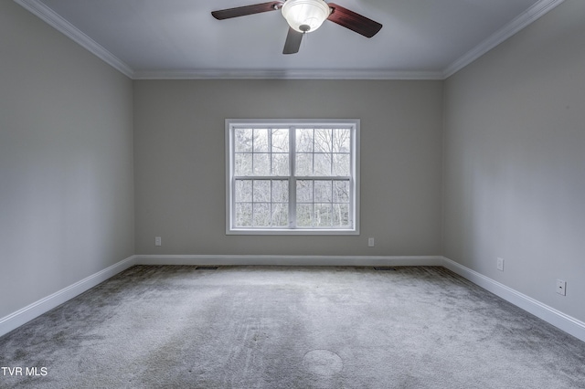 empty room featuring carpet floors, ornamental molding, and ceiling fan