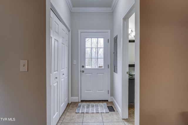 doorway with ornamental molding and light tile patterned flooring