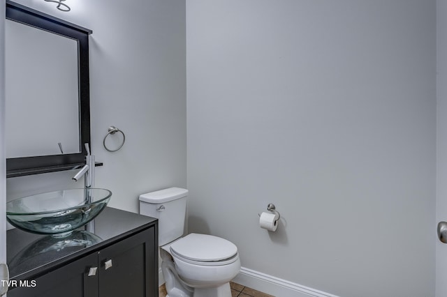 bathroom featuring vanity, toilet, and tile patterned flooring