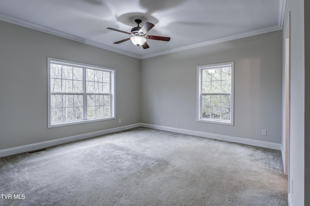 spare room featuring crown molding, light colored carpet, and ceiling fan