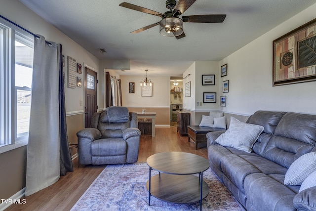 living room featuring hardwood / wood-style flooring, a wealth of natural light, and a textured ceiling