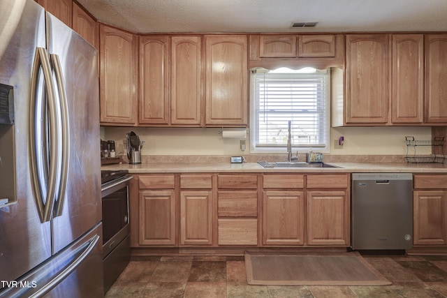 kitchen with sink and appliances with stainless steel finishes