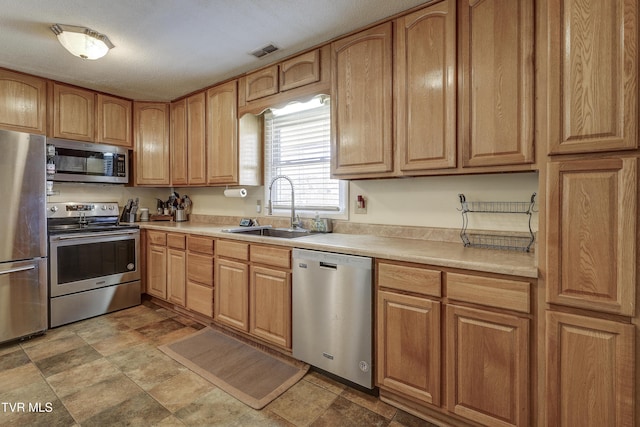 kitchen with sink and appliances with stainless steel finishes