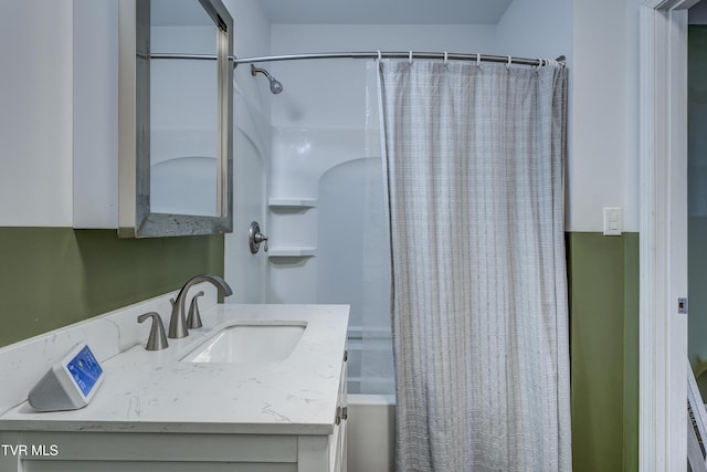 bathroom with shower / tub combo and vanity