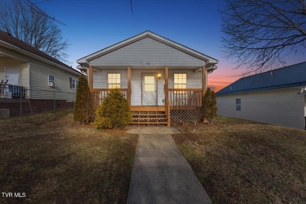 bungalow featuring a lawn and a porch