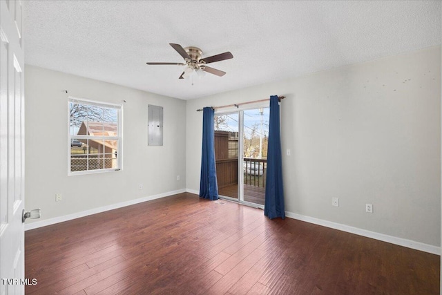 unfurnished room with dark hardwood / wood-style flooring, ceiling fan, electric panel, and a textured ceiling