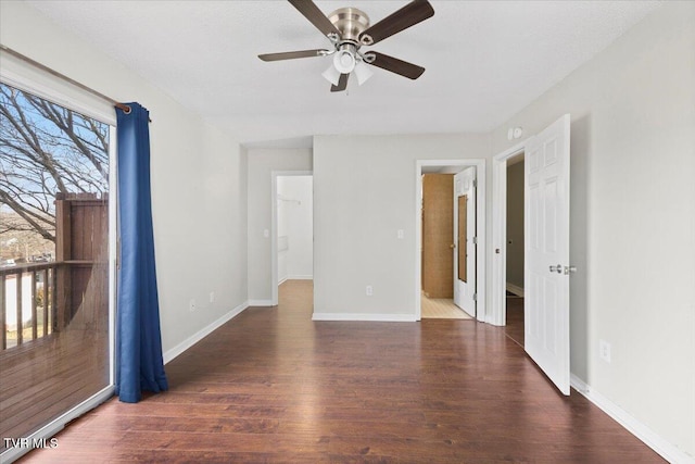 empty room featuring ceiling fan and dark hardwood / wood-style floors