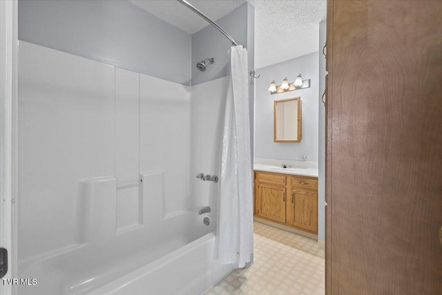 bathroom with vanity, a textured ceiling, and shower / bath combo with shower curtain