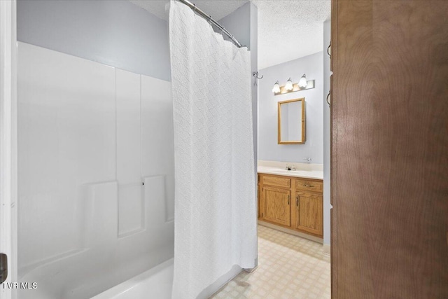 bathroom featuring vanity, a textured ceiling, and a shower with curtain