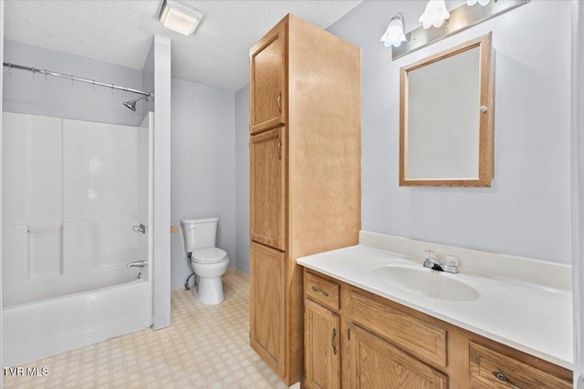 full bathroom featuring vanity, bathtub / shower combination, a textured ceiling, and toilet