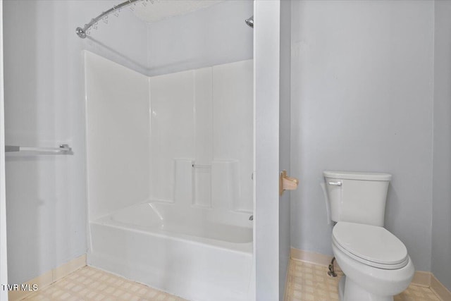 bathroom with bathing tub / shower combination and toilet