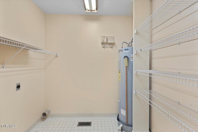 laundry room with electric water heater and hookup for an electric dryer