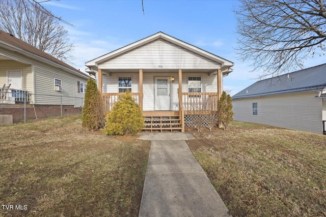 bungalow-style house featuring covered porch and a front lawn