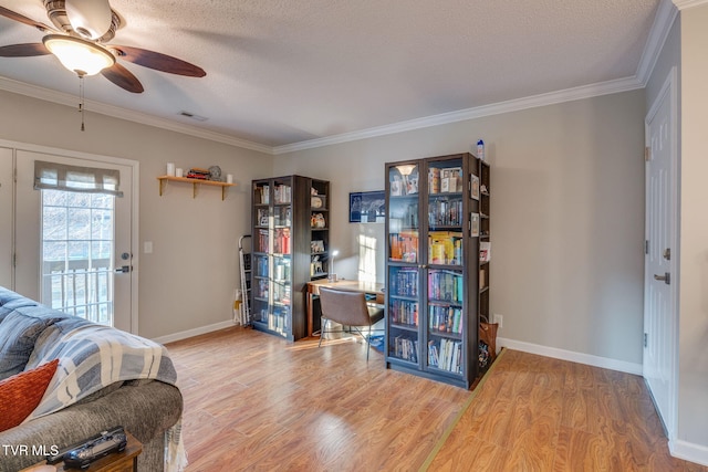 office area featuring hardwood / wood-style floors, crown molding, a textured ceiling, and ceiling fan