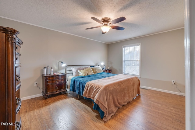 bedroom with crown molding, light hardwood / wood-style flooring, and a textured ceiling