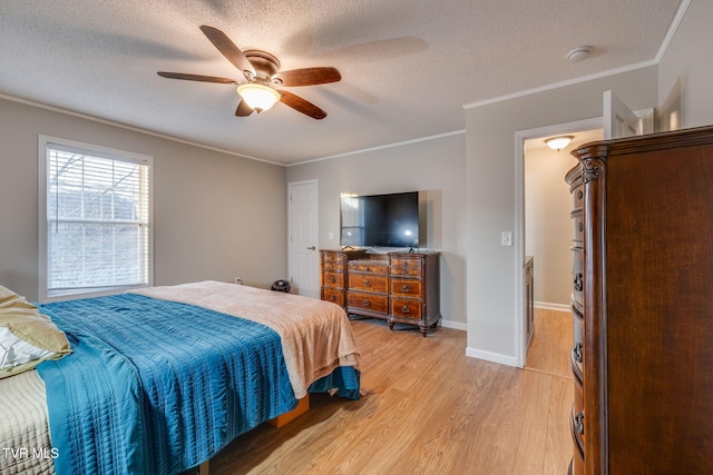 bedroom featuring ceiling fan, crown molding, light hardwood / wood-style flooring, and a textured ceiling