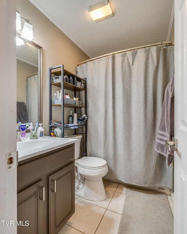 bathroom with tile patterned floors, toilet, a textured ceiling, ornamental molding, and vanity