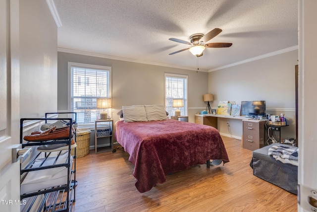 bedroom featuring hardwood / wood-style flooring, ornamental molding, and multiple windows