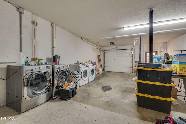 garage with washing machine and clothes dryer and a garage door opener