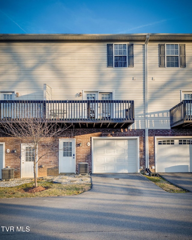 view of front of home featuring a garage and central AC unit