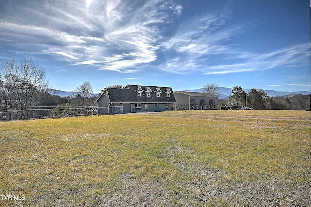 exterior space featuring a yard and a mountain view