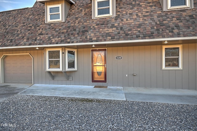 doorway to property with a garage