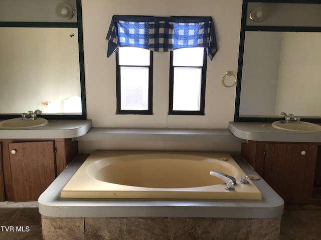 bathroom with a relaxing tiled tub and vanity