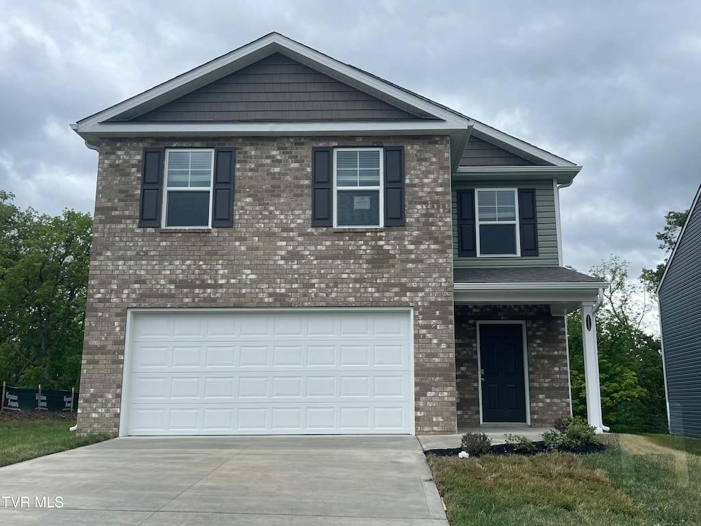 1112 Aspen Ter, Greeneville, TN 37745 - view of front facade with driveway, brick siding, and a garage