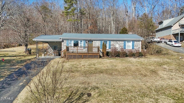 view of front of home with a wooden deck and a front lawn