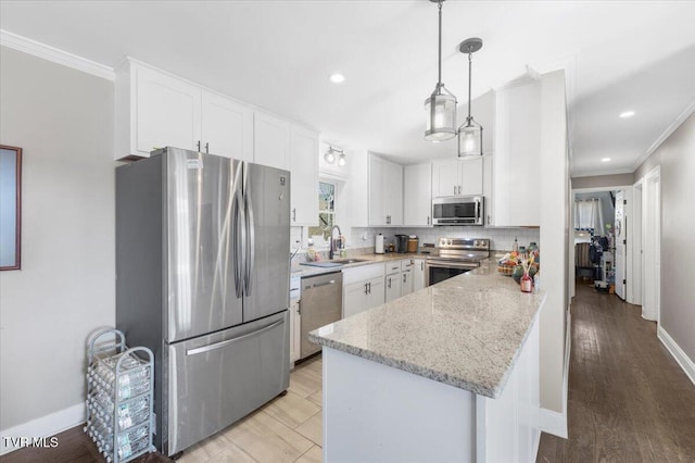 kitchen featuring white cabinetry, appliances with stainless steel finishes, sink, and backsplash