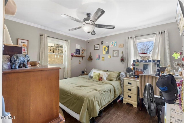 bedroom with crown molding, dark hardwood / wood-style floors, and ceiling fan