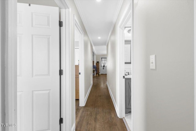 hall featuring ornamental molding and dark hardwood / wood-style flooring