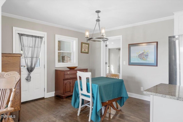 dining space with crown molding, dark wood-type flooring, and a chandelier