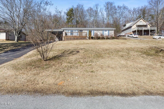 view of front of house with a front yard and a deck