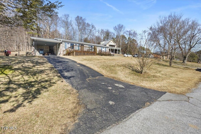 view of front of property featuring a carport and a front lawn