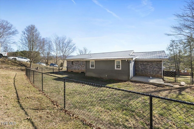 rear view of property featuring a lawn