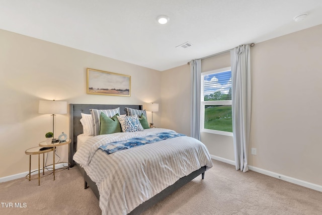 bedroom featuring light carpet