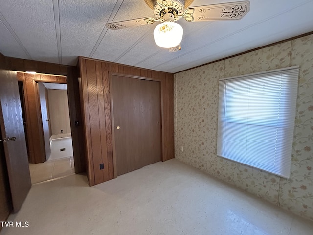 unfurnished bedroom featuring light carpet, a closet, and a textured ceiling