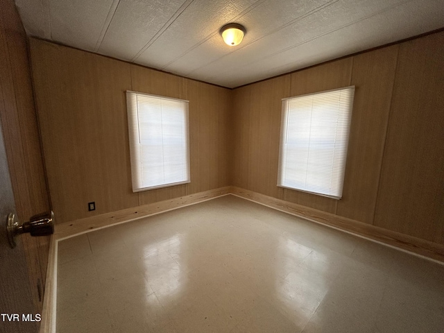 empty room featuring wood walls