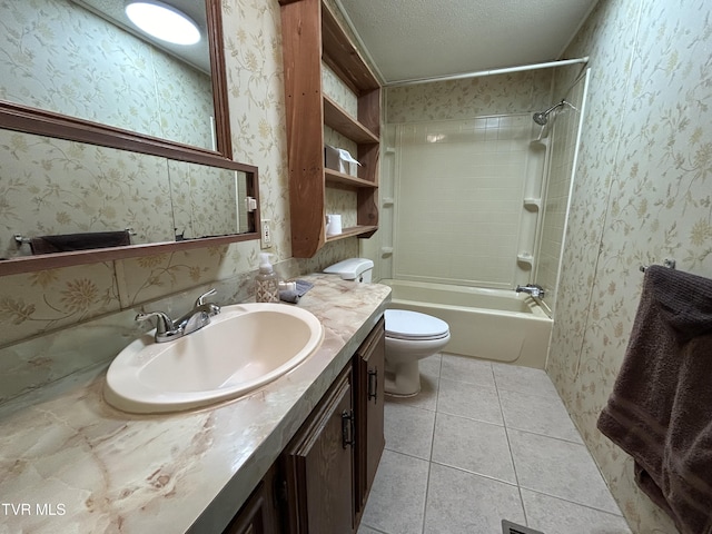 full bathroom with tile patterned flooring, tiled shower / bath combo, vanity, a textured ceiling, and toilet