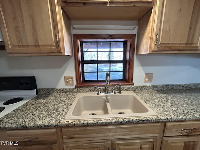 kitchen featuring sink, electric range, and light stone counters