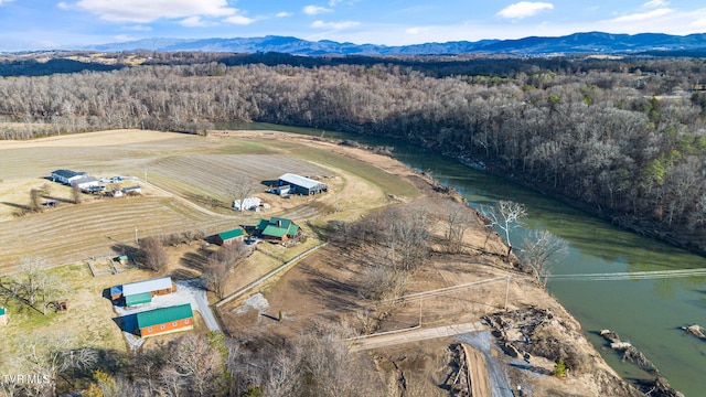 drone / aerial view featuring a water and mountain view