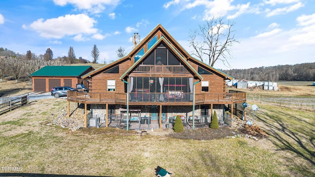 back of house featuring an outbuilding, a yard, a garage, and a deck