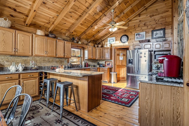 kitchen with vaulted ceiling with beams, a kitchen breakfast bar, decorative backsplash, wood ceiling, and stainless steel refrigerator with ice dispenser