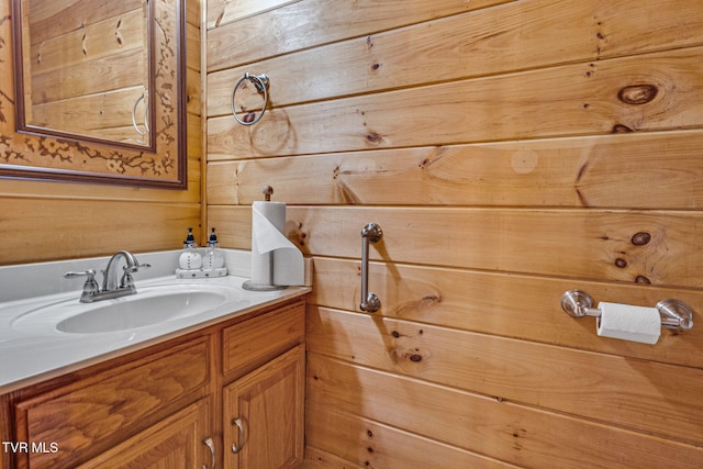 bathroom featuring vanity and wooden walls