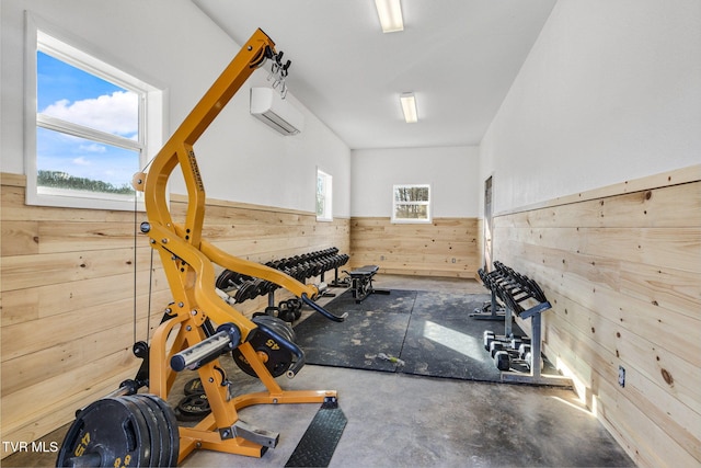 exercise room with an AC wall unit and wood walls