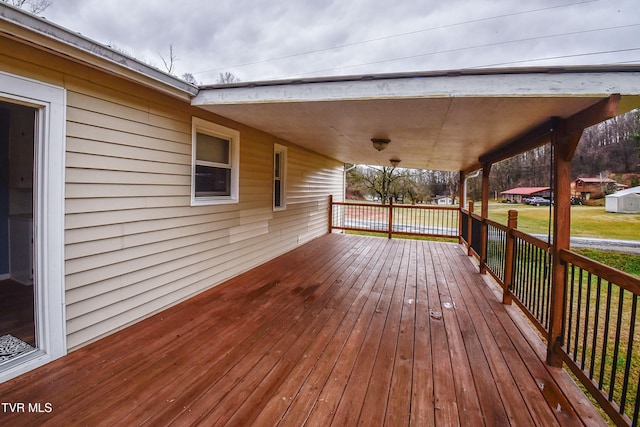 wooden deck with a lawn