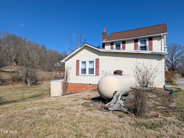 view of property exterior with a lawn