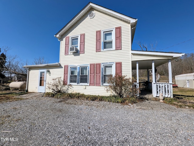 view of front of house with cooling unit and covered porch