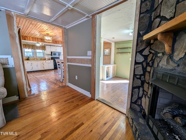 interior space with sink, wooden ceiling, and light hardwood / wood-style flooring